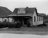caption: Barbershop in Chadds Ford, showing sign in situ, circa 1930