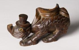 Carved fantasy animal in hat and shoes