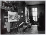 Photograph of Thornton Oakley in his studio with watercolor painting of an airplane created for…