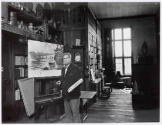 Photograph of Thornton Oakley in his studio with watercolor painting of an airplane created for…